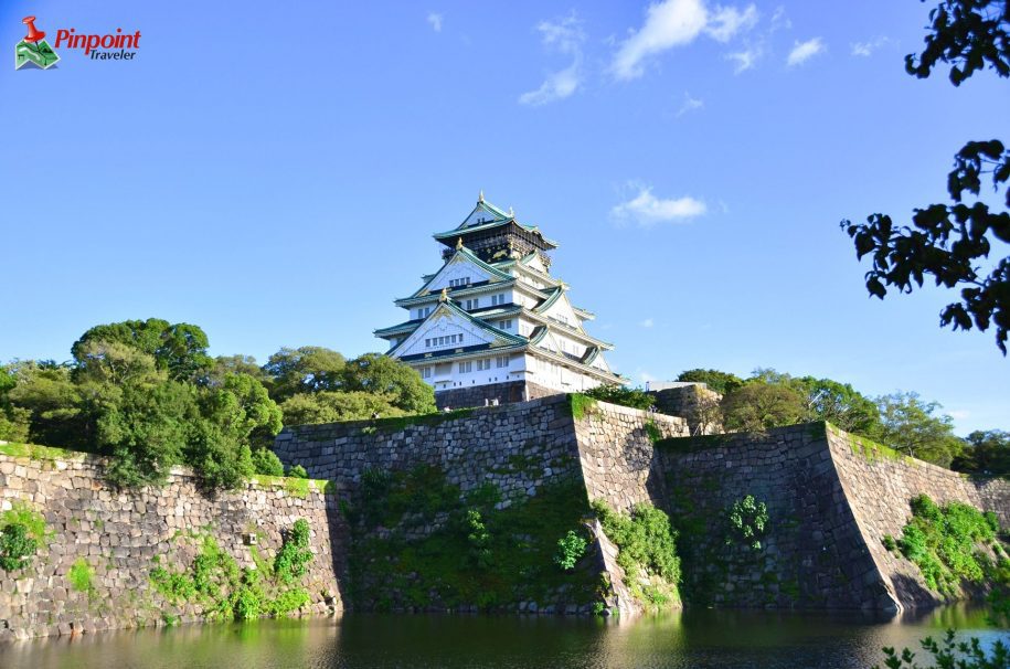 Osaka castle rising above the surrounding compound's walls.